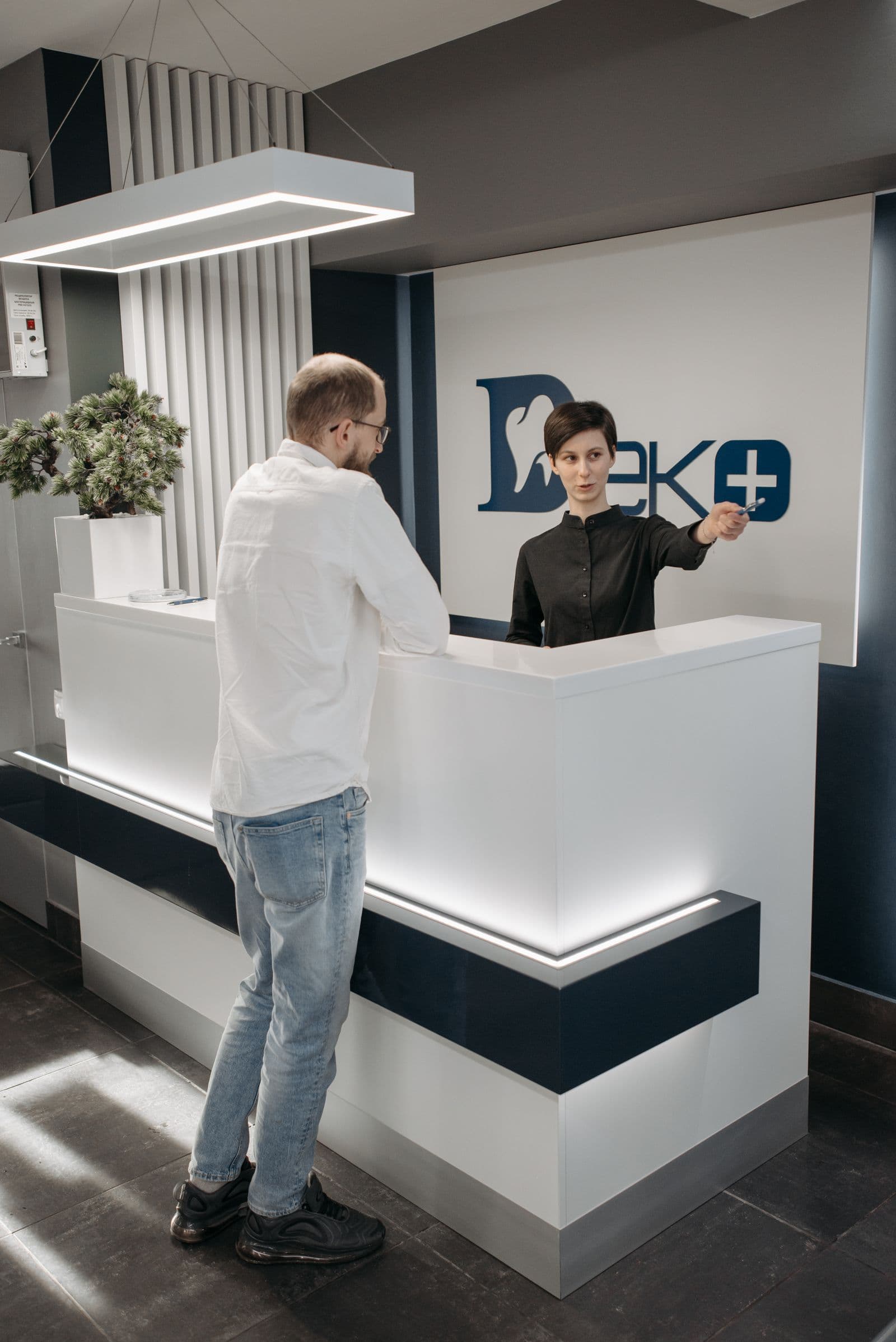 A clean, well-lit urgent care reception and check-in desk